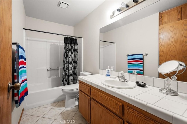 full bathroom with tile patterned flooring, vanity, toilet, and shower / bath combo with shower curtain