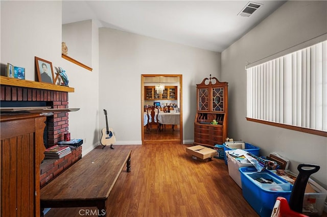 misc room featuring hardwood / wood-style flooring and lofted ceiling