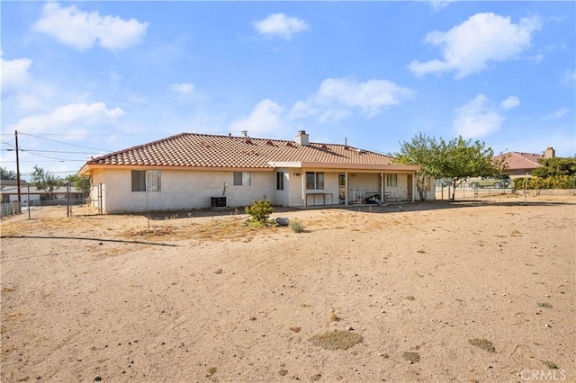 rear view of property with cooling unit