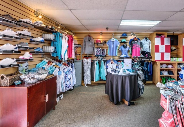 walk in closet featuring dark carpet and a drop ceiling