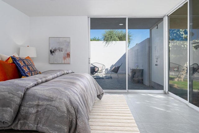 bedroom featuring access to exterior and expansive windows