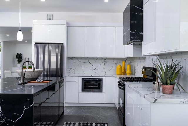 kitchen with white cabinetry, light stone counters, extractor fan, pendant lighting, and black appliances