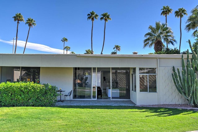 rear view of property with a yard