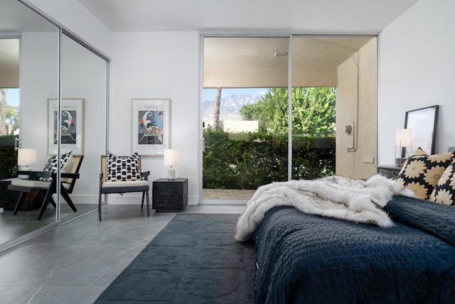 bedroom featuring concrete floors, a closet, and multiple windows