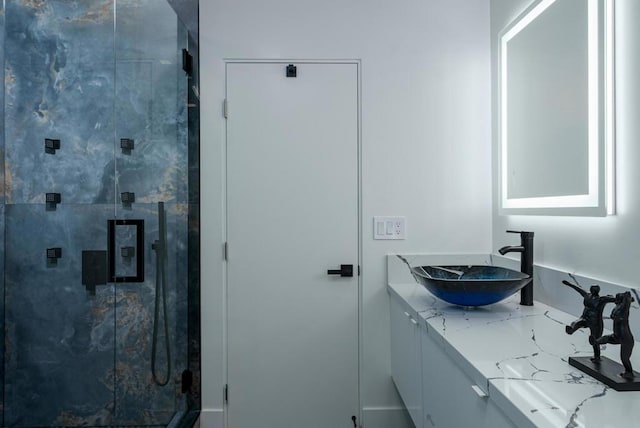 bathroom featuring vanity and a shower with door