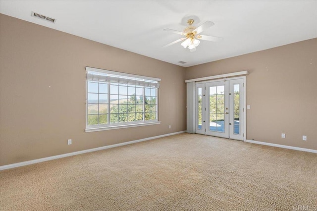 carpeted spare room featuring ceiling fan