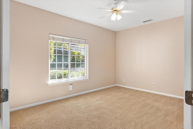 carpeted spare room with ceiling fan