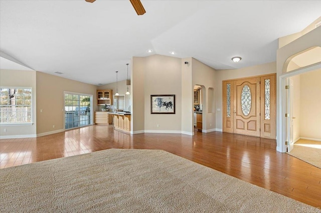 entrance foyer with vaulted ceiling, dark wood-type flooring, and ceiling fan