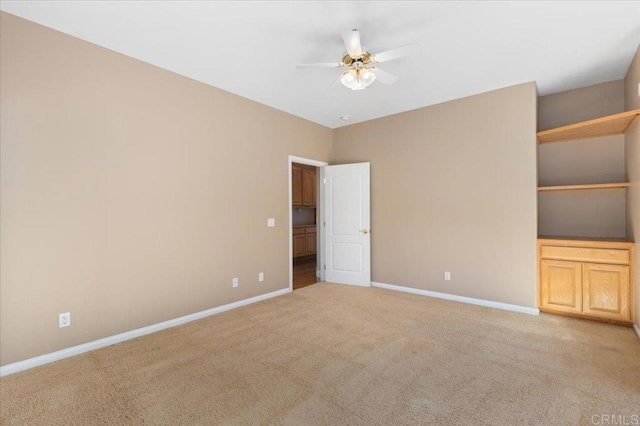 empty room with light carpet and ceiling fan