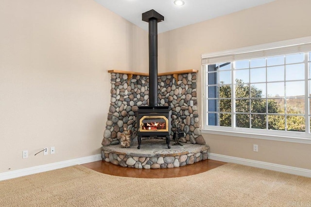 interior details with hardwood / wood-style floors and a wood stove