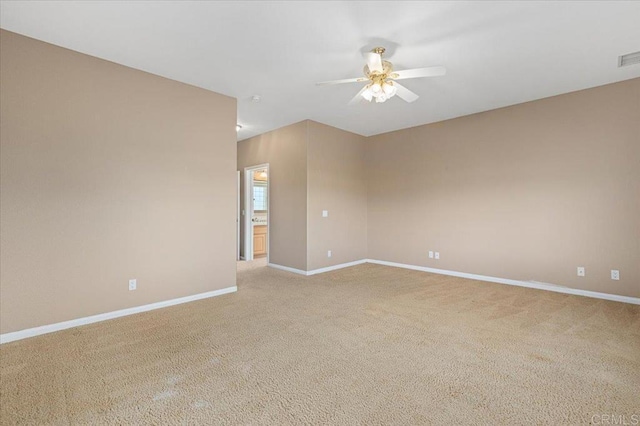 carpeted empty room featuring ceiling fan