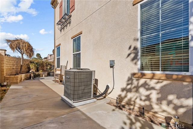 view of property exterior featuring a patio area and central AC