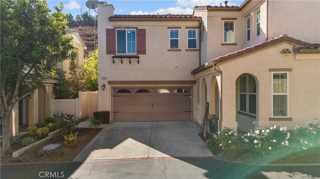 mediterranean / spanish-style house with a garage