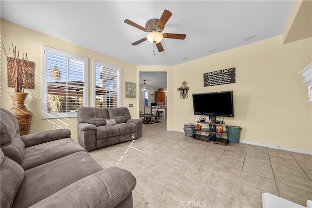 living room with light tile patterned floors and ceiling fan