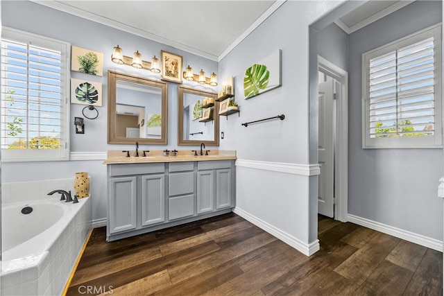 bathroom with vanity, a relaxing tiled tub, wood-type flooring, and ornamental molding