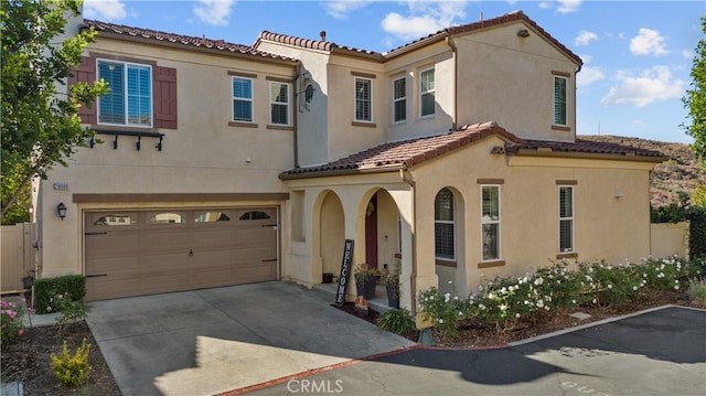 mediterranean / spanish house with a garage