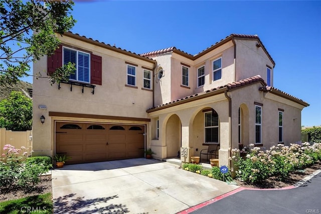 mediterranean / spanish home featuring a garage