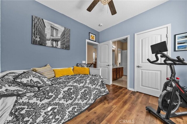 bedroom with connected bathroom, ceiling fan, and dark hardwood / wood-style flooring