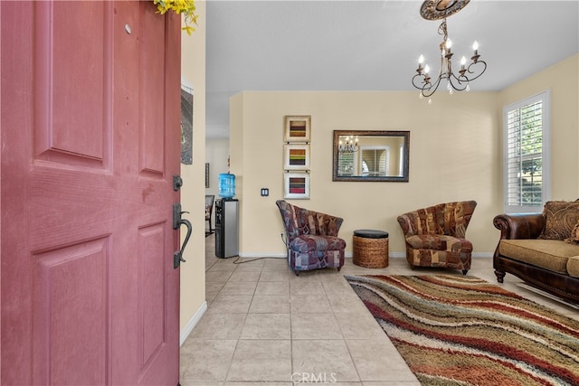 tiled foyer entrance with a chandelier