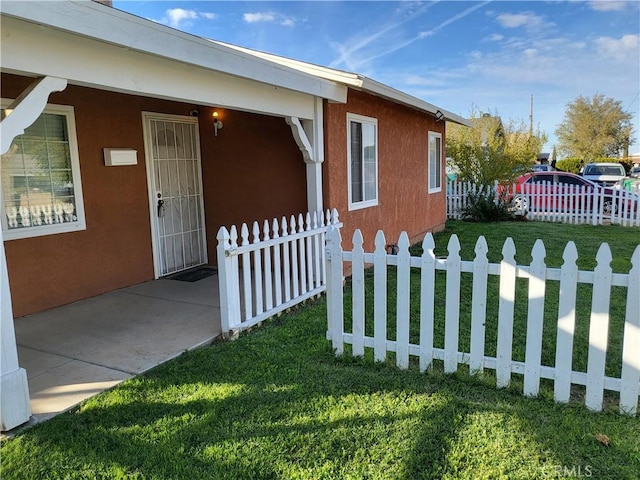 view of home's exterior featuring a yard and a patio area