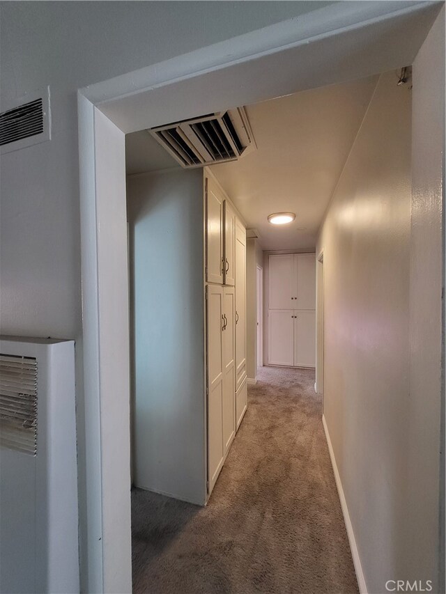 hallway with light colored carpet