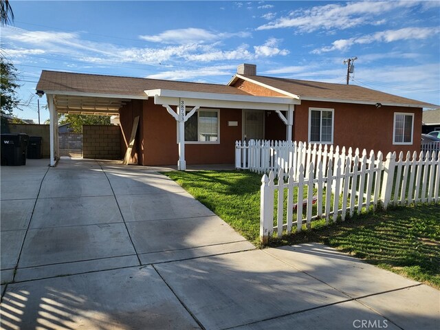 ranch-style house with a front lawn and a carport