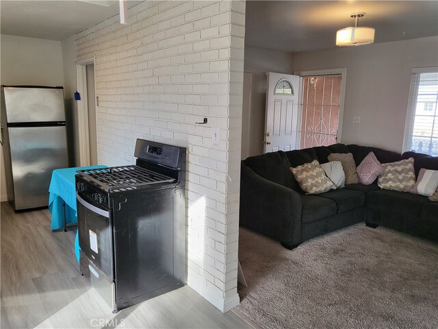 kitchen featuring light hardwood / wood-style floors and appliances with stainless steel finishes