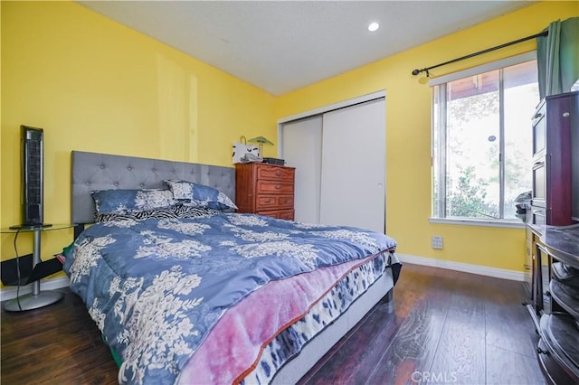 bedroom featuring dark hardwood / wood-style flooring and a closet