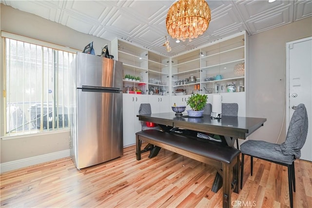 dining area with a chandelier and hardwood / wood-style flooring