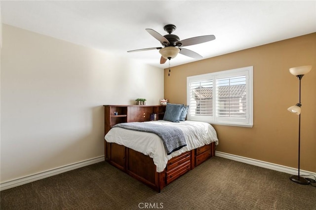 bedroom with baseboards, dark carpet, and ceiling fan