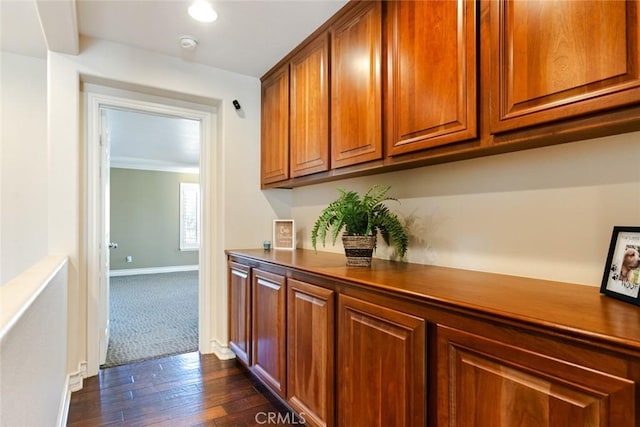 hallway with dark wood finished floors and baseboards