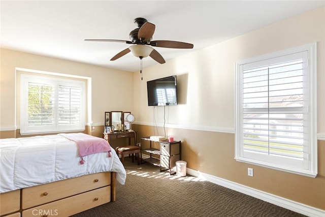 bedroom featuring dark carpet and ceiling fan