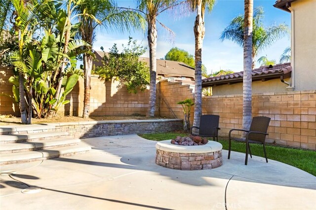 view of patio / terrace featuring a fire pit