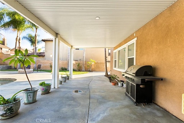 view of patio with a fenced backyard and a grill