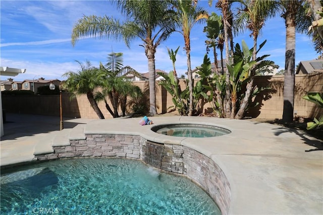 view of pool with an in ground hot tub