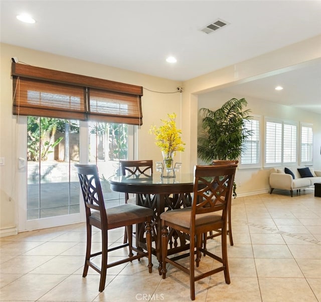 dining space featuring visible vents, plenty of natural light, and light tile patterned floors