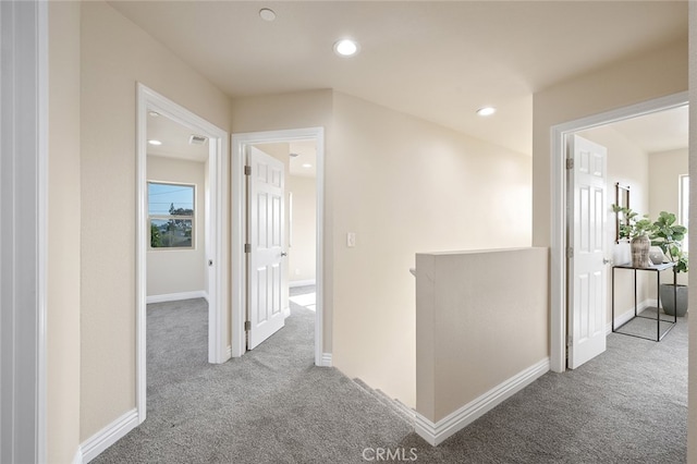 hallway featuring light carpet