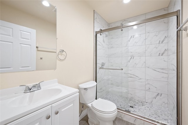 bathroom featuring vanity, toilet, and walk in shower