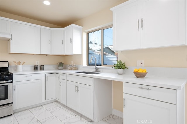 kitchen featuring white cabinets, sink, ventilation hood, and stainless steel stove