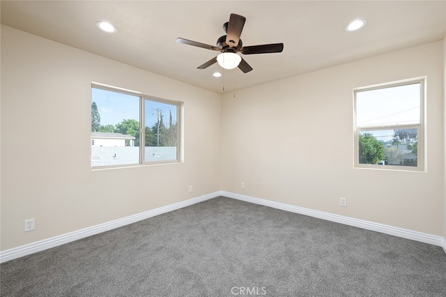 spare room featuring ceiling fan and carpet flooring