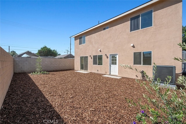 rear view of property featuring cooling unit