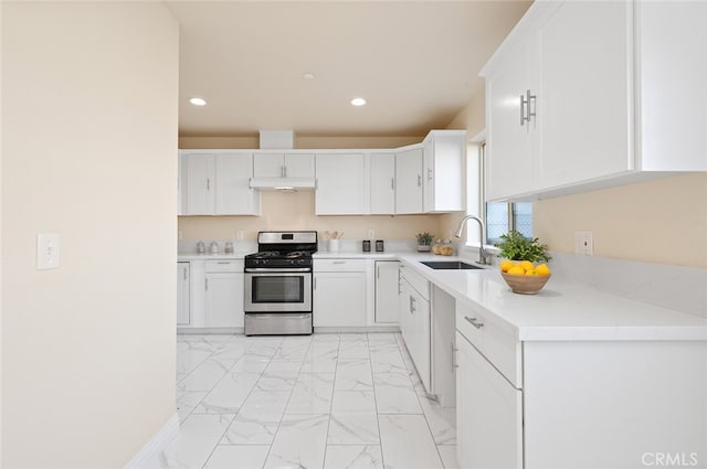 kitchen featuring white cabinets, sink, and stainless steel gas stove