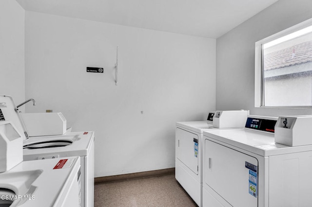 clothes washing area featuring sink and washing machine and dryer