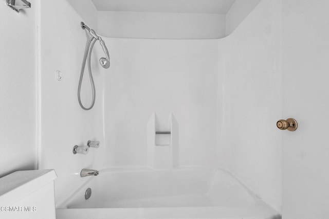 bathroom with bathtub / shower combination and toilet