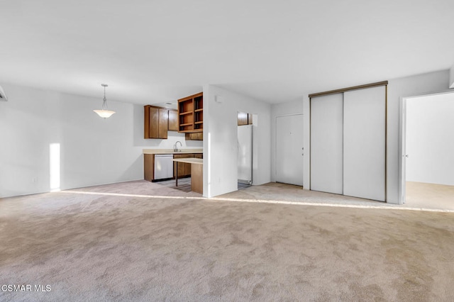 unfurnished living room featuring sink and light colored carpet