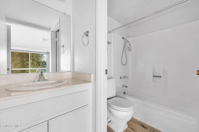 full bathroom featuring vanity, hardwood / wood-style flooring, toilet, and shower / bath combination