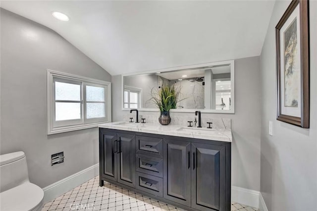 bathroom featuring vanity, toilet, lofted ceiling, and a shower