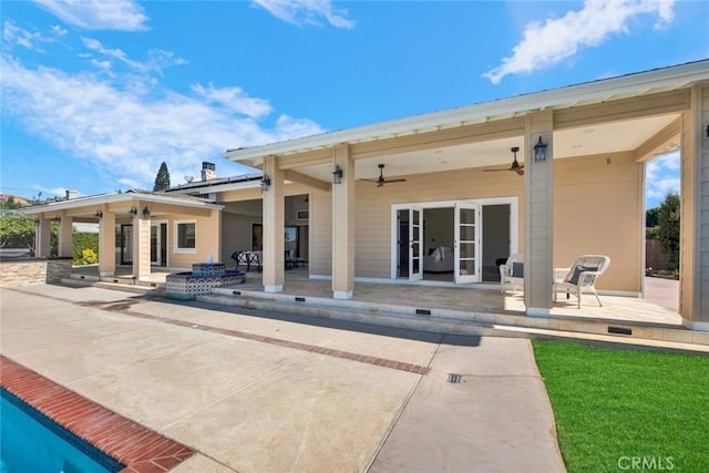 rear view of house featuring ceiling fan and a patio