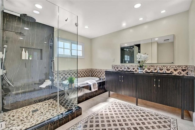 bathroom featuring vanity and independent shower and bath