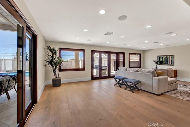 living room with light hardwood / wood-style floors and french doors